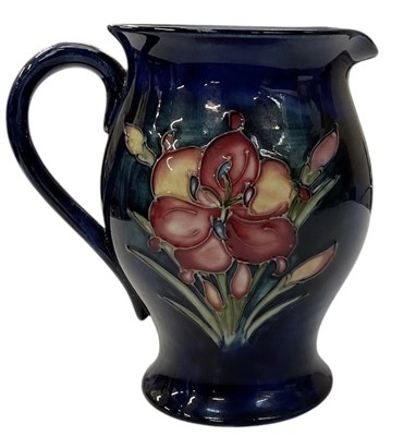 Lot 631 - MOORCROFT; a tube lined pottery jug, decorated...