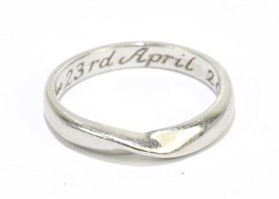 Lot 1109 - A platinum wedding band of swept design, size...