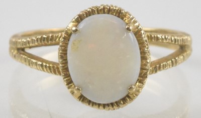 Lot 932 - A 9ct gold opal set ring, the oval claw set...