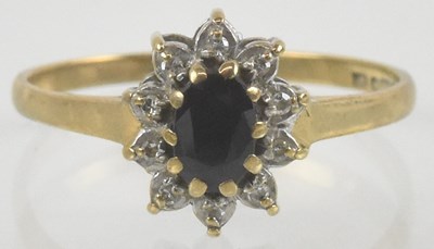 Lot 965 - A 9ct gold sapphire and diamond ring, the oval...