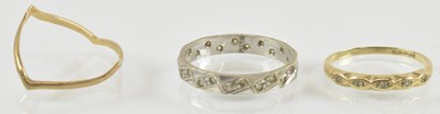 Lot 881 - Three 9ct gold rings comprising a wishbone...