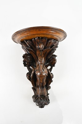 Lot 480 - A late 19th century carved oak wall bracket...