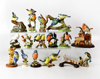 Lot 216 - Sixteen porcelain and resin figures of birds,...