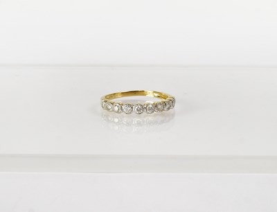 Lot 755 - A 9ct yellow gold half eternity ring set with...