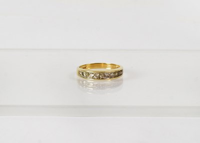 Lot 756 - A 9ct yellow gold half eternity ring set with...