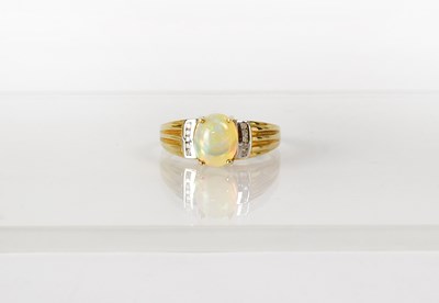 Lot 763 - A 9ct yellow gold ring set with an oval opal...