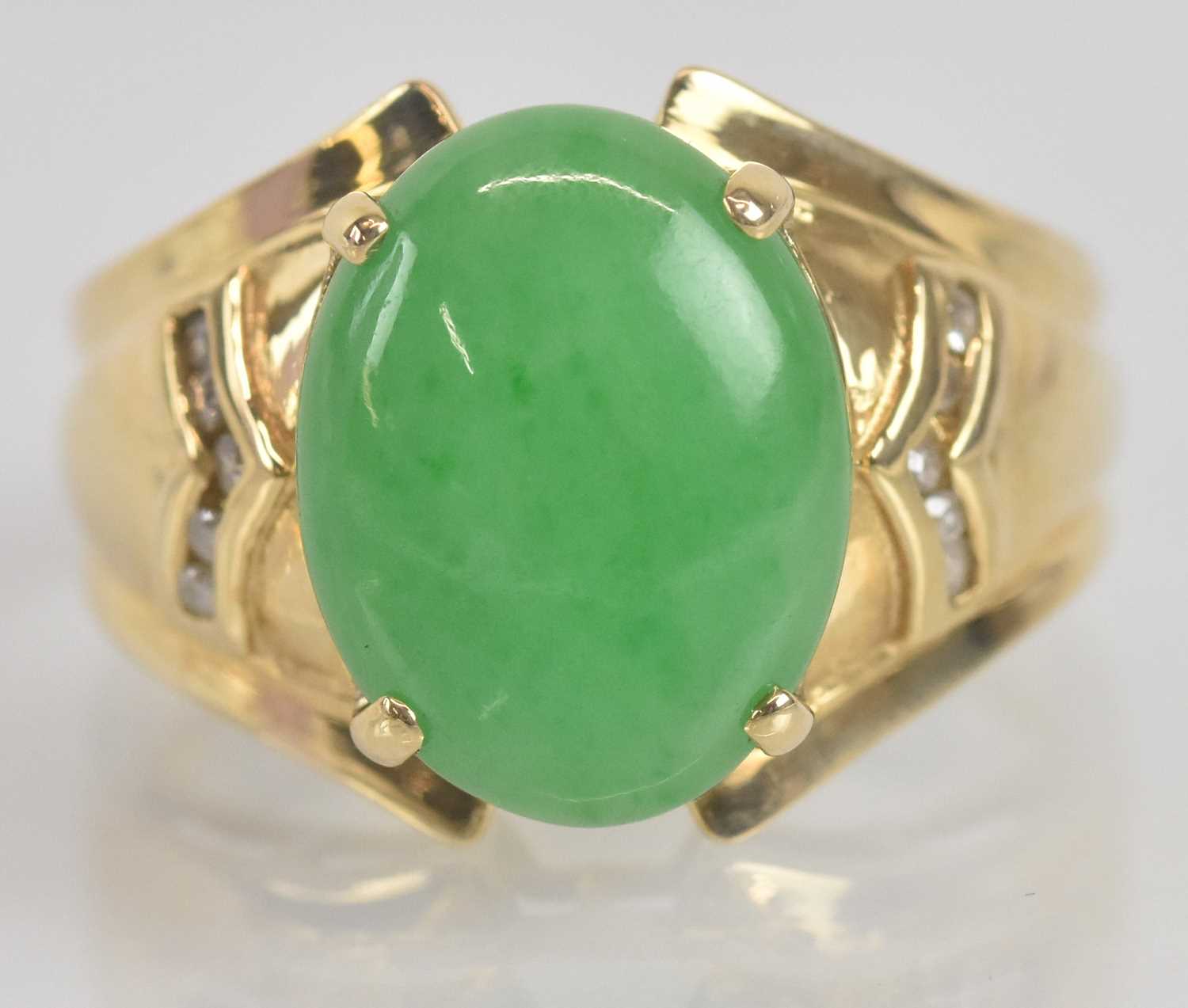 Lot 1335 - A 14ct yellow gold oval cabochon jade set ring...