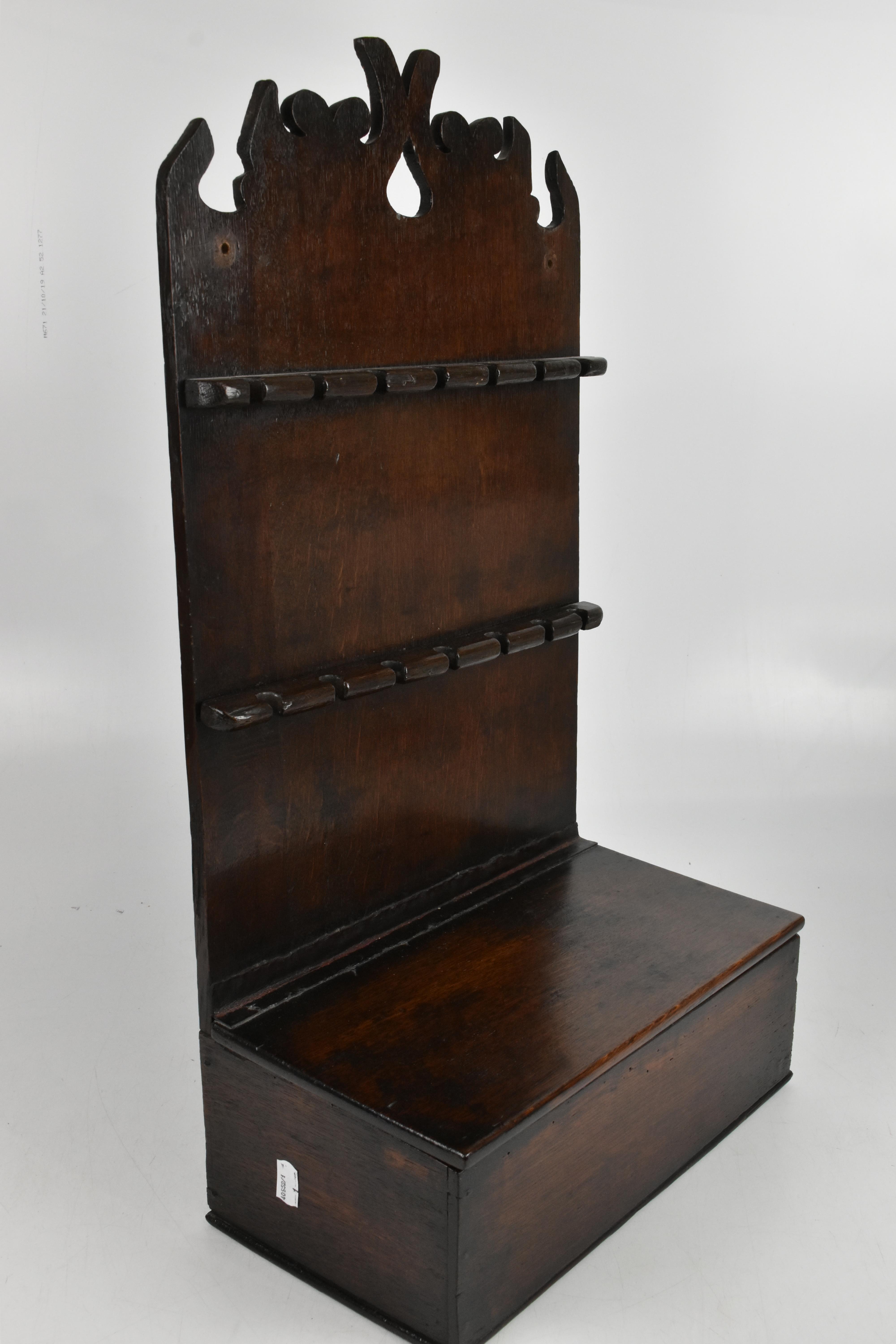 Lot 11 - A Georgian oak spoon rack, with two applied