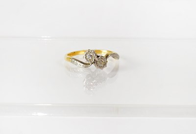 Lot 748 - An 18ct yellow gold ring illusion set with two...