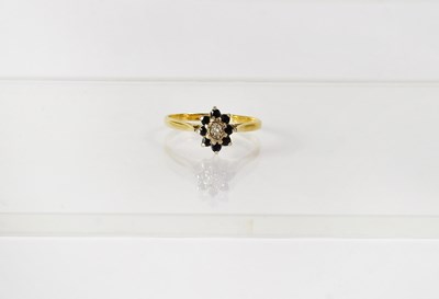 Lot 749 - An 18ct yellow gold cluster ring set with a...