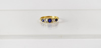 Lot 769 - A yellow metal ring set with three graduated...