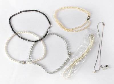 Lot 790 - Five pearl necklaces of various colours,...