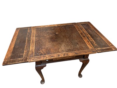 Lot 299 - A 1920s/30s oak draw-leaf dining table on...