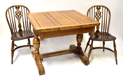 Lot 25 - An early 20th century oak draw-leaf table and...