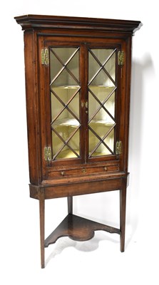 Lot 104 - A 19th century mahogany corner cupboard with...