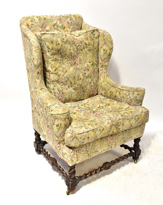 Lot 45 - A Georgian-style oak framed wing back armchair,...