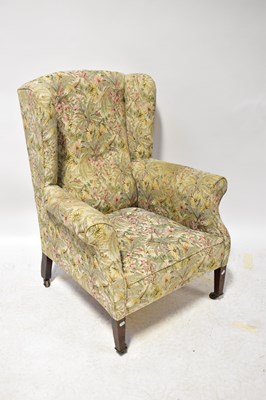 Lot 52 - A Georgian-style mahogany wing-back armchair...