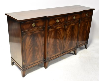 Lot 112 - A Regency-style mahogany breakfront sideboard...