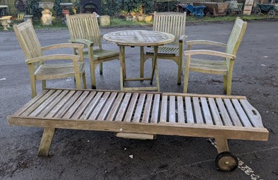 Lot 337 - A teak garden folding table and four elbow...