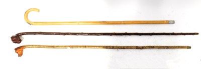 Lot 332 - Two 19th century walking sticks, with carved...