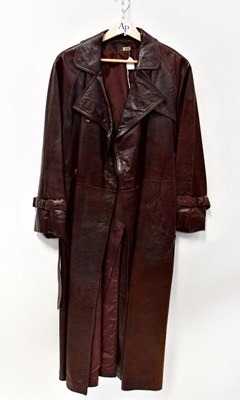 Lot 362 - A double-breasted, brown leather trench coat...