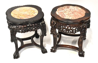 Lot 21 - A near pair of Chinese hardwood stands with...