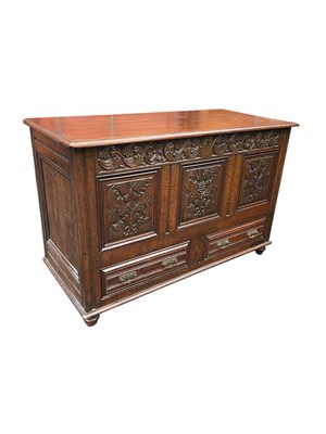 Lot 102 - An 18th century style carved oak coffer with...