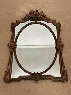 Lot 388 - A decorative gilt wood mirror, with a oval...