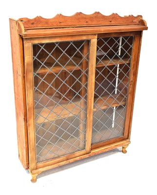 Lot 84 - A pine bookcase with a pair of leaded glazed...