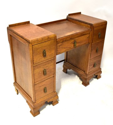 Lot 58 - A 1930s oak desk/dressing table, comprising a...