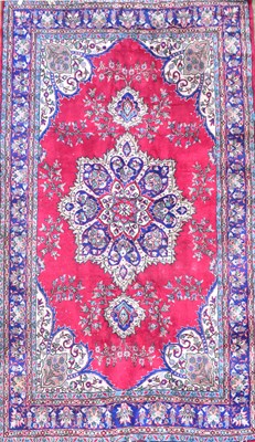 Lot 156 - A Caucasian red wool carpet, with central...