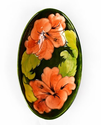 Lot 224 - MOORCROFT; a 'Hibiscus' pattern oval dish of...