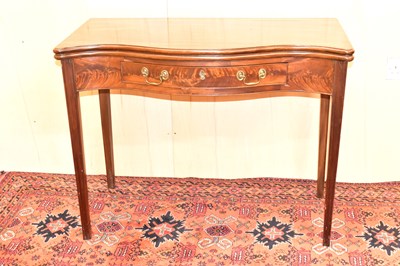 Lot 9 - A mahogany tea table with serpentine front...