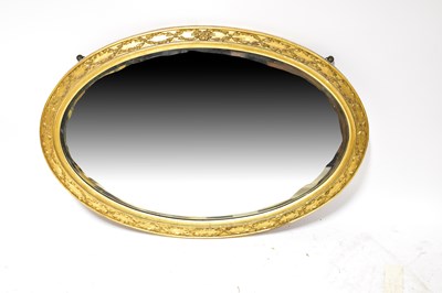 Lot 138 - A gilt framed oval wall mirror, with relief...