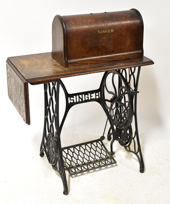 Lot 130 - SINGER; a treadle sewing machine, with wrought...