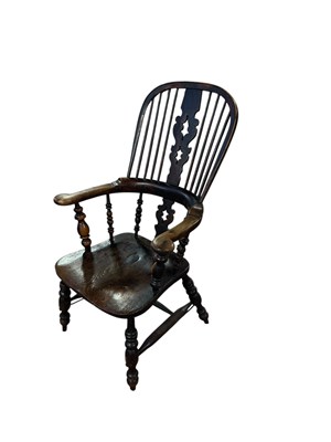 Lot 106 - A 19th century elm seated Windsor elbow chair.