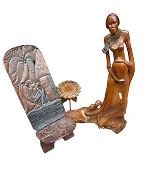 Lot 293 - An African carved hardwood chair, decorated...