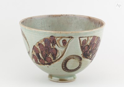 Lot 737 - A deep stoneware bowl covered in pale green...