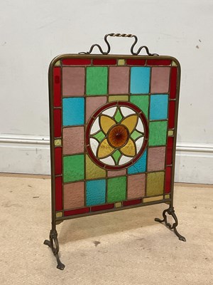 Lot 758 - A Victorian brass framed fire screen, with...