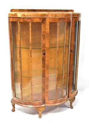 Lot 99 - A 1930s walnut bow-fronted display cabinet on...