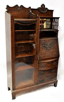 Lot 116 - An Edwardian oak student's desk/glazed...