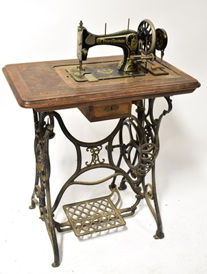 Lot 131 - FRISTER & ROSSMAN; a treadle sewing machine...