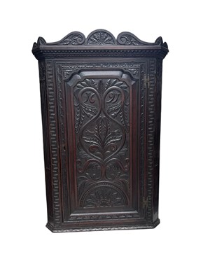 Lot 123 - A late 18th century carved oak hanging corner...