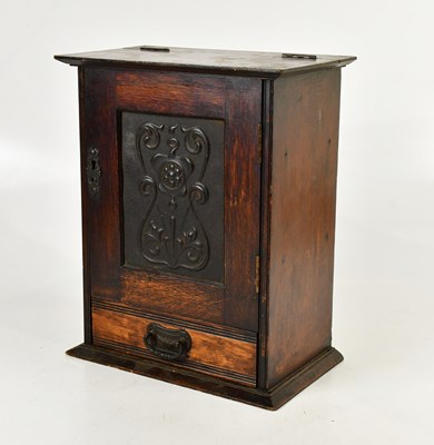 Lot 548 - An Arts and Crafts oak smoker's cabinet with...