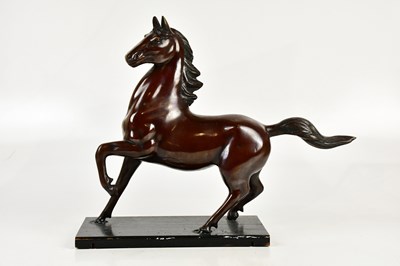 Lot 714 - A decorative bronzed model of a horse on...