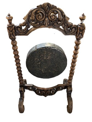 Lot 213 - A carved oak framed freestanding dinner gong...