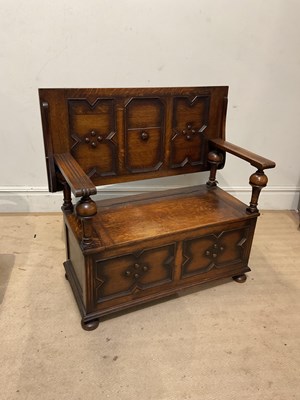 Lot 214 - An early 20th century oak monk's bench with...