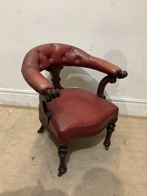 Lot 265 - A Victorian maroon leather upholstered tub chair.