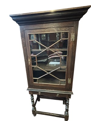 Lot 206 - A dark oak display cabinet, the moulded...