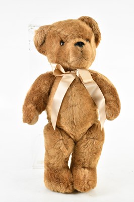 Lot 1168 - MERRYTHOUGHT; a brown fur bear with bow, 55cm.